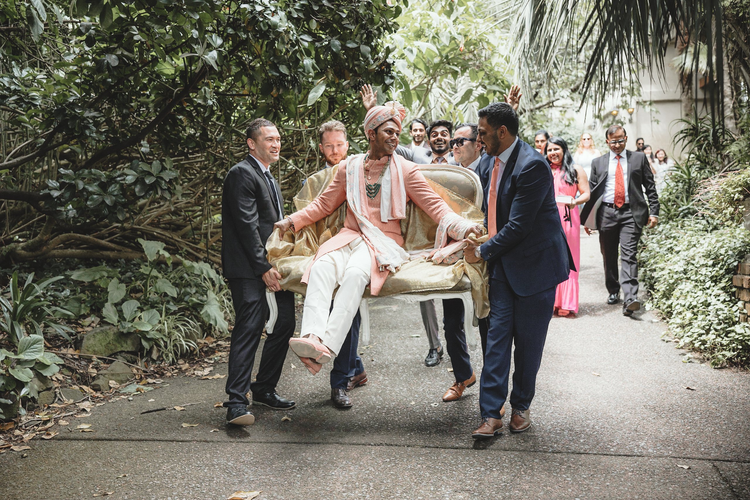 Groom lifted by his friends at an Indian wedding in Auckland
