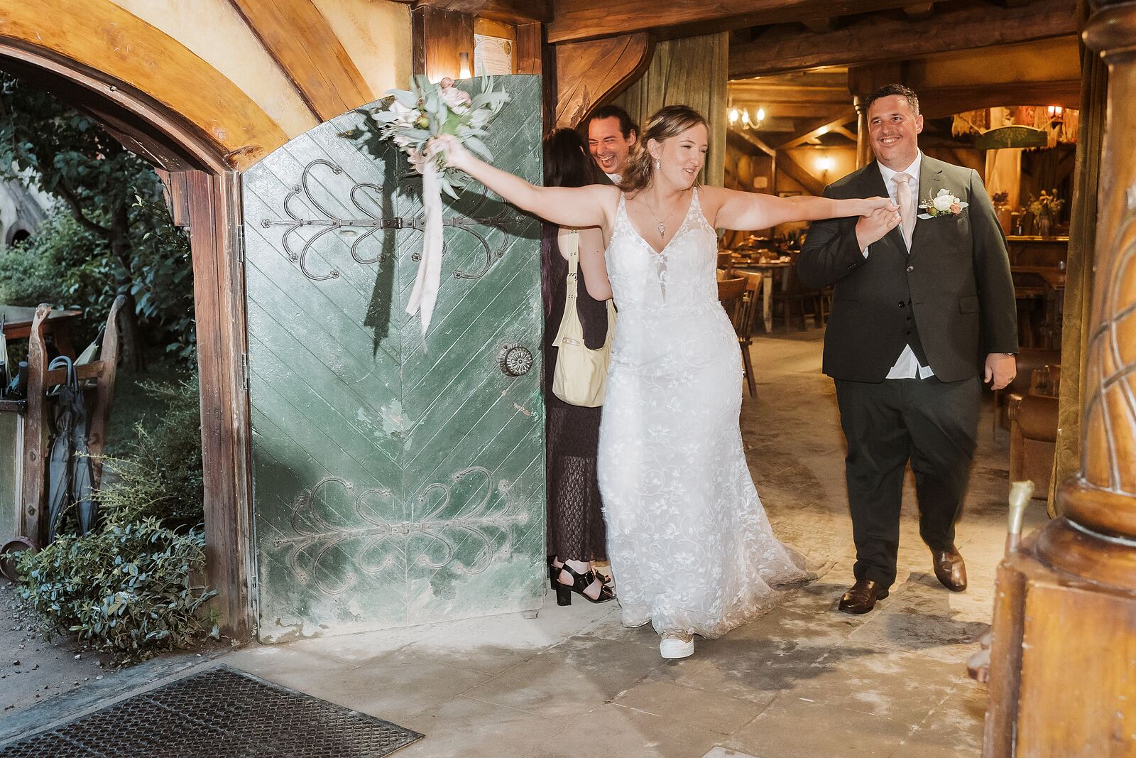 Bride and groom entering the Green Dragon Inn at Hobbiton