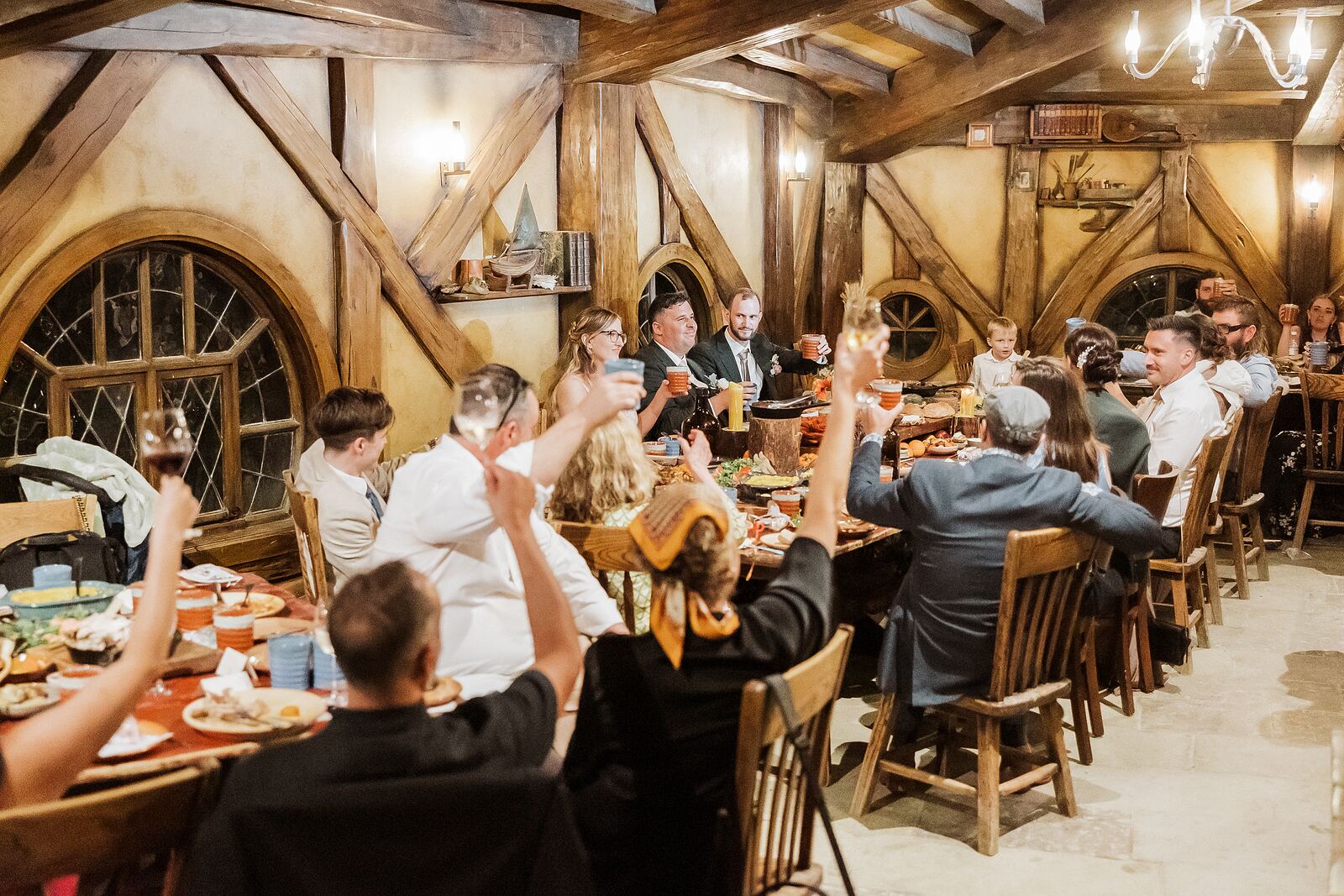 Wedding guests raising a toast inside the Green Dragon Inn
