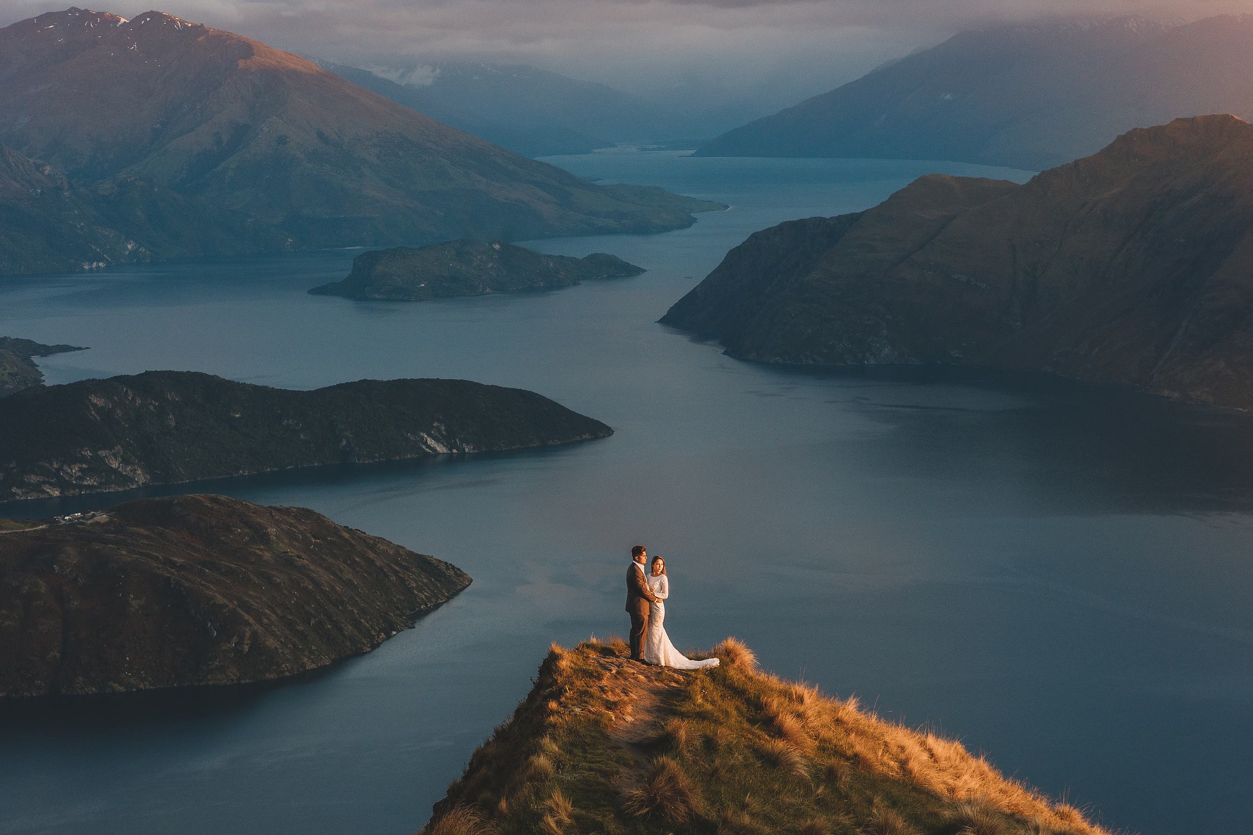 Couple on a ridge above Lake Wanaka at sunset, Central Otago