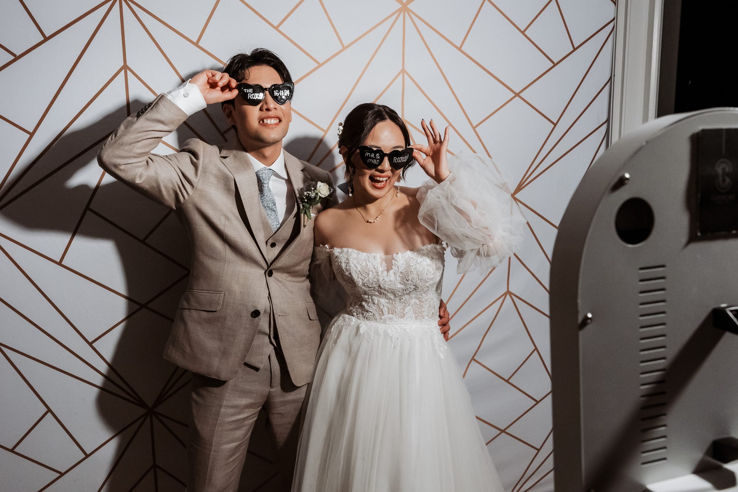 Guests posing at a 360 glam booth at an Auckland wedding